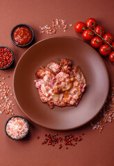 Cooked crispy fried pork bacon strips for a hearty breakfast. Fried bacon strips