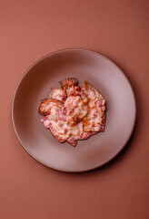 Cooked crispy fried pork bacon strips for a hearty breakfast. Fried bacon strips