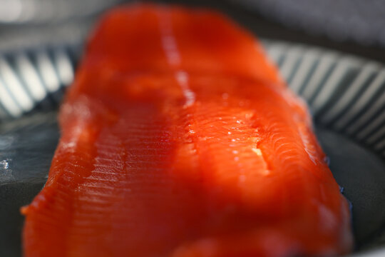 Vibrant red meat on a raw fillet of fresh caught wild Coho Salmon. The fish is healthy food. 
