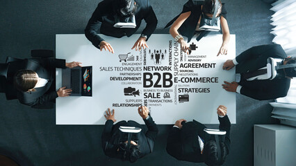 Engaging business meeting showcasing professionals collaborating on B2B strategies, e-commerce opportunities, and effective sales techniques in a dynamic environment. Amity