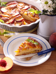Homemade peach cake, sliced on plate
