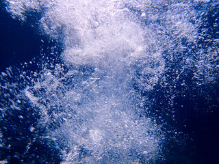 Ocean blue underwater with sunrays, Underwater Sea Deep Water Abstract Sunshine, sea wave , clean waters in summer time, Natural underwater seascape, sand on ocean floor and water surface with sunligh