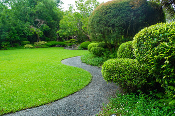 Naklejka premium Garden landscape design with pathway in garden and footpath in picturesque summer park and staircase in backyard,Paving stones on floor in park,space for text.