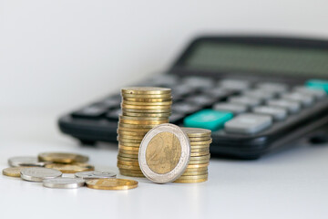 Stacked Coins with Calculator and Wallet