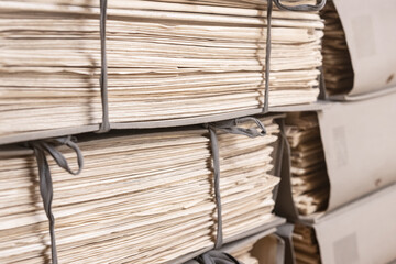 Old files stacked in folders background. Stacks of weathered working Paper documents