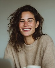 Fototapeta premium Woman with long brown hair is smiling and wearing a sweater