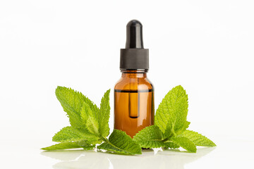 Peppermint essential oil on white background. Herbal remedies