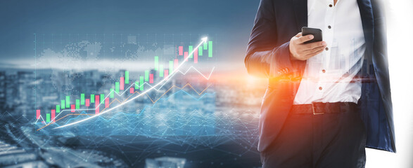 A businessman in a suit uses a smartphone in front of a cityscape while stock market charts illustrate growth. This image represents financial success. Impute