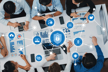 Top view analyst team utilizing BI Fintech to analyze financial data at table in meeting room. Analytic BI dashboard power on paper for business insight and strategic marketing planning. Prudent Amity