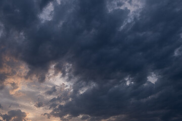 Dramatic sky with stormy clouds at sunset. Nature background.