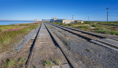 Obraz premium Train tracks beside the Churchill River leading to the Port of Churchill, Manitoba, Canada