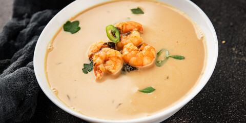 Tom kha soup shrimp, coconut milk, miso paste tasty seafood snack fresh delicious gourmet food background on the table rustic food top view copy space pescetarian diet