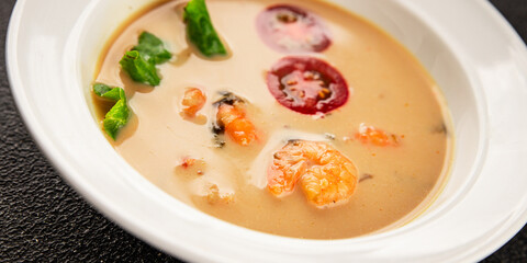 Tom kha soup shrimp, coconut milk, miso paste tasty seafood snack fresh delicious gourmet food background on the table rustic food top view copy space pescetarian diet