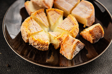 Cheese plate camembert, brie, munster french cheese tasty snack fresh delicious gourmet food background on the table rustic food top view copy space
