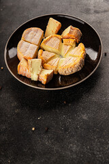 Cheese plate camembert, brie, munster french cheese tasty snack fresh delicious gourmet food background on the table rustic food top view copy space