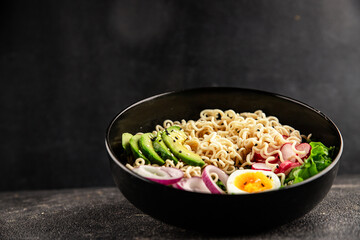 Vegetarian noodle bowl avocado, noodles, egg, vegetables tasty snack fresh delicious gourmet food background on the table rustic food top view copy space keto and paleo diet vegetarian food