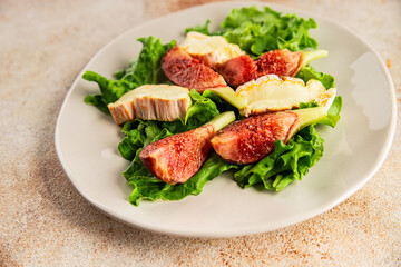 Salad figs, soft cheese, green leaf lettuce tasty snack fresh delicious gourmet food background on the table rustic food top view copy space keto and paleo diet vegetarian food