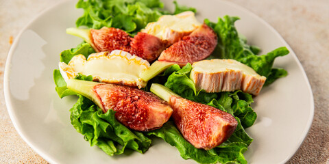 Salad figs, soft cheese, green leaf lettuce tasty snack fresh delicious gourmet food background on the table rustic food top view copy space keto and paleo diet vegetarian food