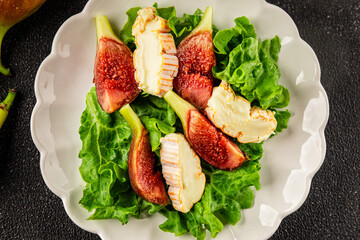 Salad figs, soft cheese, green leaf lettuce tasty snack fresh delicious gourmet food background on the table rustic food top view copy space keto and paleo diet vegetarian food