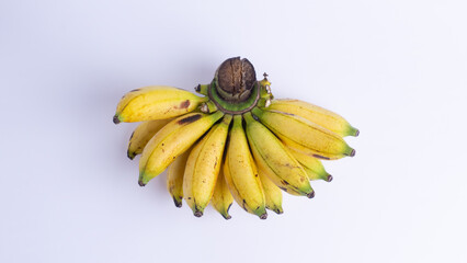 Ripe yellow bananas arranged in flat lay on white background. Fresh tropical fruit isolated for healthy diet, organic food, natural snack, and versatile ingredient use.
