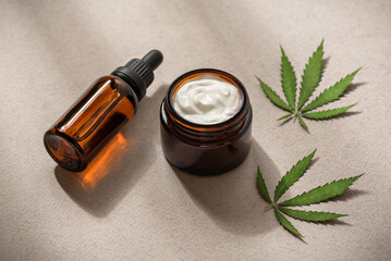 Face cream with cannabis and oil serum in an amber dropper bottle. THC tincture, CBD oil and hemp...