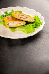 Cutlet cordon bleu meat chicken, cheese, ham second course french cuisine tasty snack fresh delicious gourmet food background on the table rustic food top view copy space