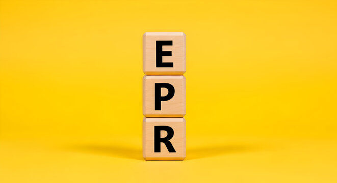 Stacked wooden cubes forming acronym EPR on yellow background &mdash; extended producer responsibility concept for recycling and circular economy