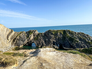 Jurassic coast view in Dorset, England, UK. Stair Hole near Lulworth Cove. Lulworth Cove cliffs view on a way to Durdle Door. The Jurassic Coast is a World Heritage Site on the English Channel coast