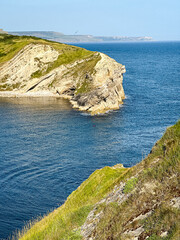 Lulworth Cove bay, beach and cliffs view . The Jurassic Coast is a World Heritage Site on the English Channel coast of southern England. Dorset, UK. crowded beach, public beach.