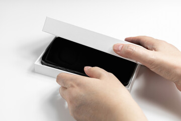 Closeup of female hands holding phone box