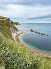 Man O'War Beach on Jurassic Coast, Dorset, England, UK. Scenic bay surrounded by Jurassic Coast rocks. Sunny summer days. beautiful landscape and seascape view. English Channel sea view. Cliffs, rocks