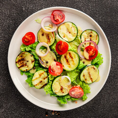 Salad grilled zucchini, tomato, lettuce tasty snack fresh delicious gourmet food background on the table rustic food top view copy space keto and paleo diet vegan and vegetarian food