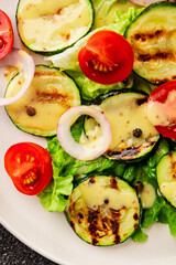 Salad grilled zucchini, tomato, lettuce tasty snack fresh delicious gourmet food background on the table rustic food top view copy space keto and paleo diet vegan and vegetarian food