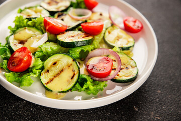 Salad grilled zucchini, tomato, lettuce tasty snack fresh delicious gourmet food background on the table rustic food top view copy space keto and paleo diet vegan and vegetarian food