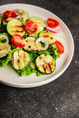 Salad grilled zucchini, tomato, lettuce tasty snack fresh delicious gourmet food background on the table rustic food top view copy space keto and paleo diet vegan and vegetarian food