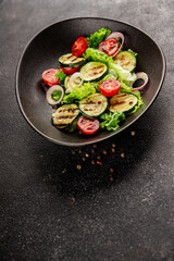 Salad grilled zucchini, tomato, lettuce tasty snack fresh delicious gourmet food background on the table rustic food top view copy space keto and paleo diet vegan and vegetarian food
