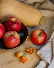 autumn still life with apples, pumpkin and physalis