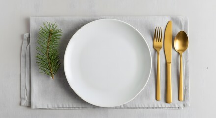Elegant table setting with golden cutlery and white plate for dining or celebration