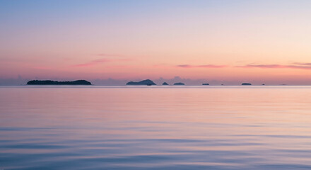 Fototapeta premium Tropical Sunset Serenity Vast Ocean, Calm Waters, Glassy Reflections, and Islands Silhouette Under a Gradient Sky