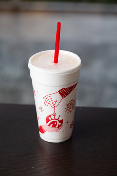  Christmas design Chick-fil-a cup filled with their famous lemonade on the table with a red straw