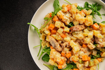 Potato salad with smoked fish tasty snack fresh delicious gourmet food background on the table rustic food top view copy space
