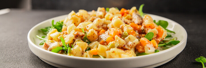 Potato salad with smoked fish tasty snack fresh delicious gourmet food background on the table rustic food top view copy space