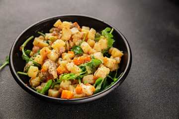 Potato salad with smoked fish tasty snack fresh delicious gourmet food background on the table rustic food top view copy space