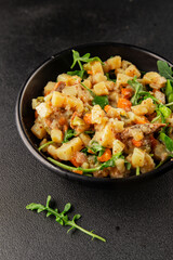 Potato salad with smoked fish tasty snack fresh delicious gourmet food background on the table rustic food top view copy space