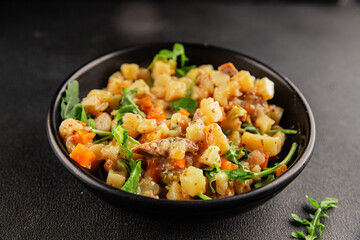 Potato salad with smoked fish tasty snack fresh delicious gourmet food background on the table rustic food top view copy space
