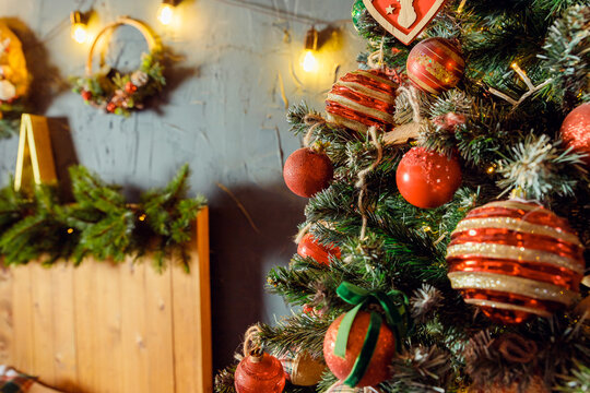 Classic Christmass or New Year decoration with a lot of gift boxes under spruce in a bedroom. Vintage New Year decor. Christmas mood. interior with New Year's holiday sparkling garland.