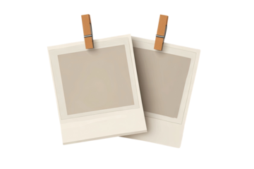 Two blank instant photos, beige background, clothespins