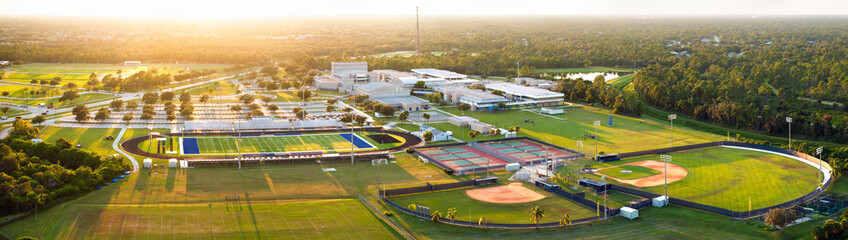 Sports facilities at public school in North Port, Florida. American football stadium, tennis court and baseball diamond sport infrastructure © bilanol