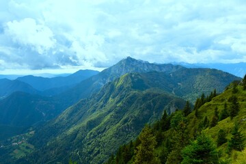 Obraz premium Črna Prst mountain and forest covered slopes in Julian alps, Gorenjska, Slovenia