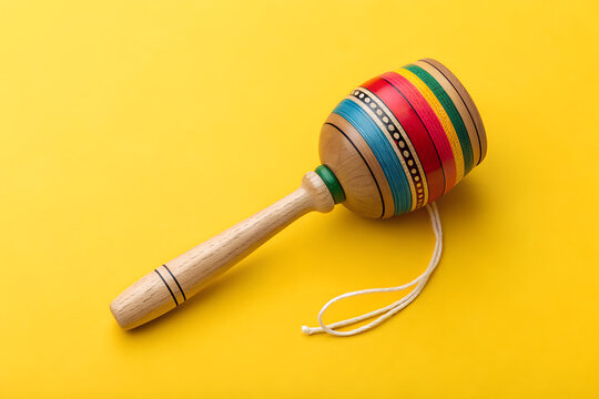 Vibrant Wooden Balero Toy on Yellow Background 
